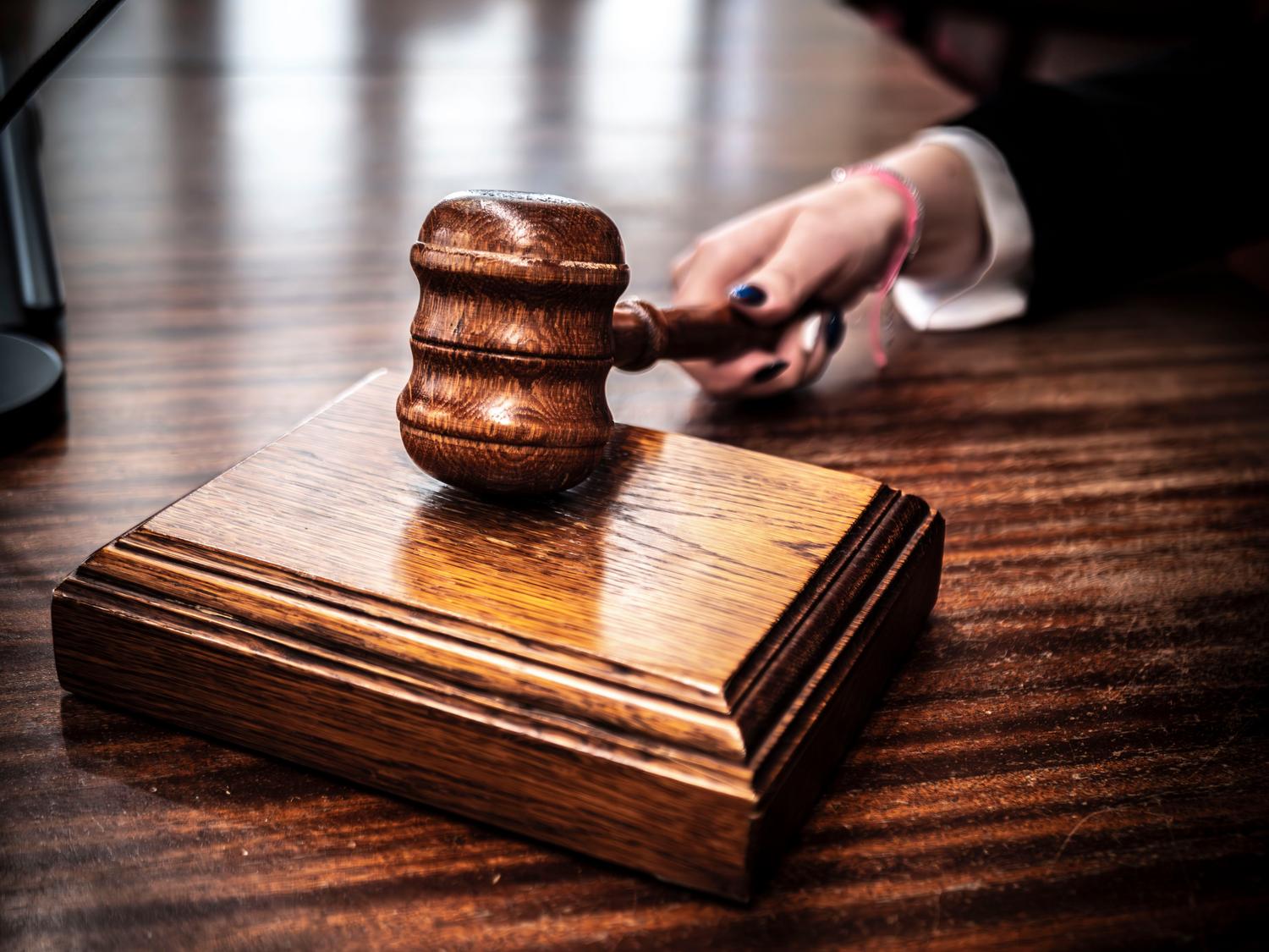 Primer plano de un mazo de madera sobre la mesa de un juez, simbolizando la justicia y el ámbito judicial. Primer plano de un mazo de madera sobre la mesa de un juez, simbolizando la justicia y el ámbito judicial.