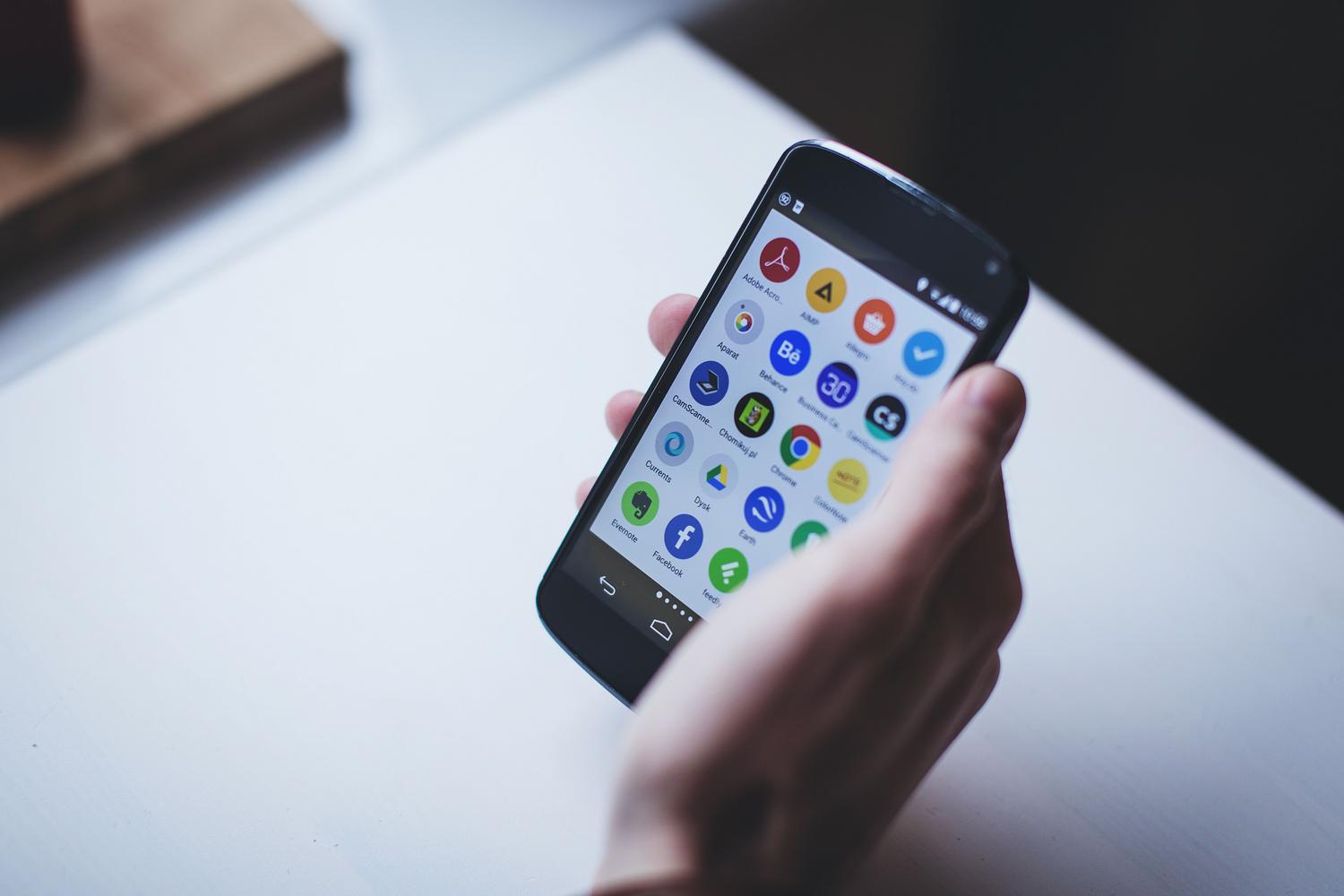 Primer plano de un smartphone mostrando una variedad de iconos de aplicaciones instaladas, representando el despliegue final de una app en las tiendas. Primer plano de un smartphone mostrando una variedad de iconos de aplicaciones instaladas, representando el despliegue final de una app en las tiendas.