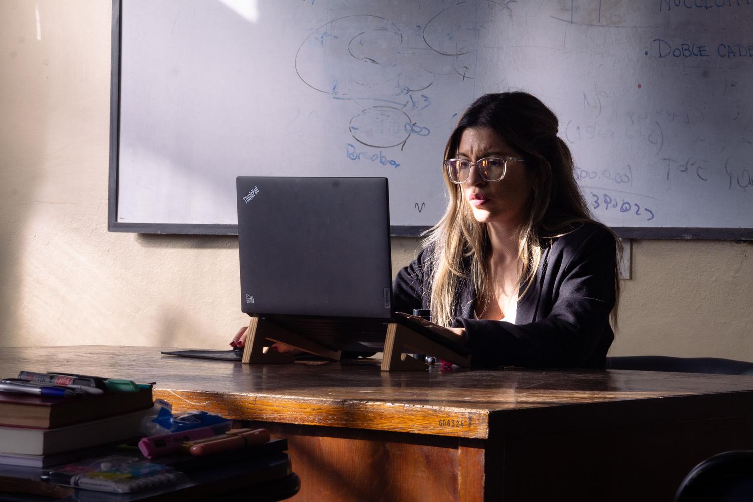 Educadora utilizando un ordenador portátil en clase, ilustrando la digitalización y la IA aplicada a la educación. Educadora utilizando un ordenador portátil en clase, ilustrando la digitalización y la IA aplicada a la educación.